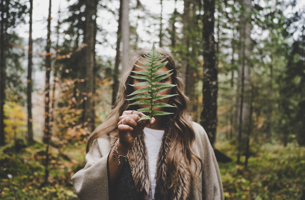 Woman holding a leaf while visiting a provincial park